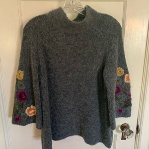 Anthropologie Sweater with embroidered sleeves.